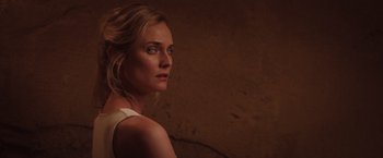 Movie still from “The Host” (2013), directed by Andrew Niccol – A woman is looking into the distance in a dark room; Close Up shot, Low angle