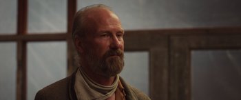 Movie still from “The Host” (2013), directed by Andrew Niccol – An older man with a beard and a mustache; Close Up shot, Low angle
