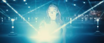 Movie still from “The Host” (2013), directed by Andrew Niccol – A woman standing in front of some lights in a room; Medium shot, Low angle