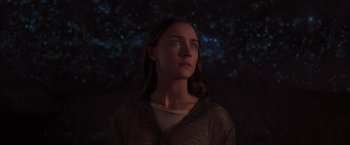 Movie still from “The Host” (2013), directed by Andrew Niccol – A woman standing in front of some trees at night; Close Up shot, Low angle