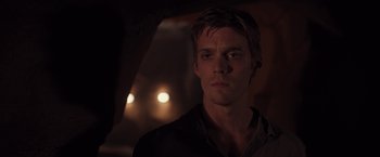Movie still from “The Host” (2013), directed by Andrew Niccol – A young man is looking into the camera; Close Up shot, Over the shoulder angle