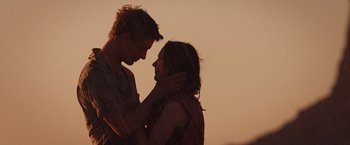 Movie still from “The Host” (2013), directed by Andrew Niccol – A man and a woman standing next to each other; Medium shot, Low angle