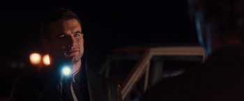 Movie still from “The Host” (2013), directed by Andrew Niccol – A person wearing a suit and tie; Close Up shot, Over the shoulder angle