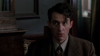 Movie still from “The Hours” (2002), directed by Stephen Daldry – A person wearing a suit and tie; Close Up shot, Low angle