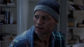 Movie still from “The Hours” (2002), directed by Stephen Daldry – An older man wearing a hat and a blue shirt; Close Up shot, Over the shoulder angle