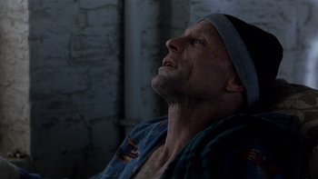 Movie still from “The Hours” (2002), directed by Stephen Daldry – A person laying in a bed near a brick wall; Close Up shot, High angle