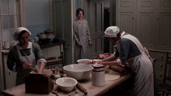Movie still from “The Hours” (2002), directed by Stephen Daldry – A group of people preparing food in a kitchen; Medium shot, High angle