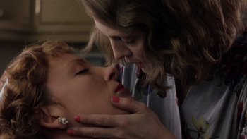 Movie still from “The Hours” (2002), directed by Stephen Daldry – A woman kissing another woman's face in a room; Close Up shot, Low angle