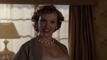 Movie still from “The Hours” (2002), directed by Stephen Daldry – A woman wearing a dress and a necklace; Close Up shot, Low angle