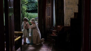 Movie still from “The Hours” (2002), directed by Stephen Daldry – A woman helping a little girl put on a hat; Wide shot, High angle