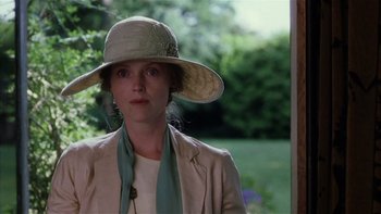Movie still from “The Hours” (2002), directed by Stephen Daldry – A woman wearing a hat standing in front of a window; Close Up shot, Low angle