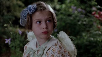 Movie still from “The Hours” (2002), directed by Stephen Daldry – A little girl with a bow in her hair; Close Up shot, High angle