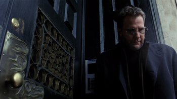 Movie still from “The Hours” (2002), directed by Stephen Daldry – A man standing in front of a wall; Close Up shot, Low angle