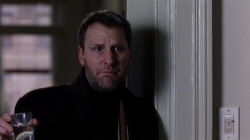 Movie still from “The Hours” (2002), directed by Stephen Daldry – A person wearing a suit and tie; Close Up shot, Over the shoulder angle