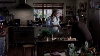 Movie still from “The Hours” (2002), directed by Stephen Daldry – A man and a woman in a kitchen preparing food; Medium shot, High angle