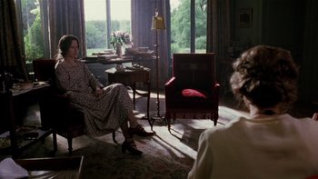Movie still from “The Hours” (2002), directed by Stephen Daldry – Two women sitting in chairs in a living room; Wide shot, Over the shoulder angle