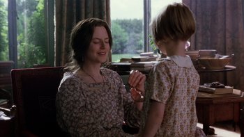 Movie still from “The Hours” (2002), directed by Stephen Daldry – A woman sitting next to a little girl in front of a window; Medium shot, Over the shoulder angle