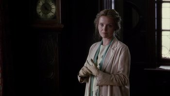 Movie still from “The Hours” (2002), directed by Stephen Daldry – A woman standing in front of a clock in a dark room; Medium shot, Low angle