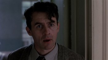 Movie still from “The Hours” (2002), directed by Stephen Daldry – A person wearing a suit and tie; Close Up shot, Low angle