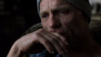 Movie still from “The Hours” (2002), directed by Stephen Daldry – An old man with a hat on is holding his hands to his face; Close Up shot, High angle