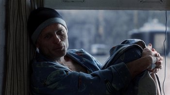 Movie still from “The Hours” (2002), directed by Stephen Daldry – A man wearing pajamas and a hat looking out of a window; Close Up shot, Low angle