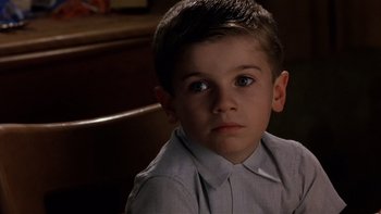 Movie still from “The Hours” (2002), directed by Stephen Daldry – A young boy sitting in a chair looking at the camera; Close Up shot, High angle