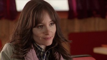 Movie still from “The House of the Devil” (2009), directed by Ti West – A person with long hair; Close Up shot, Over the shoulder angle