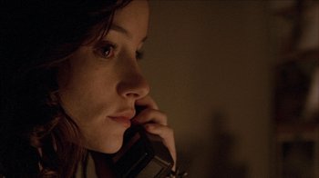 Movie still from “The House of the Devil” (2009), directed by Ti West – A woman is talking on a cell phone; Close Up shot, Low angle