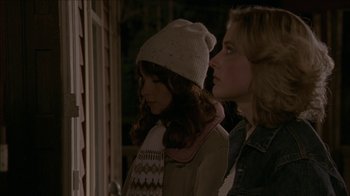 Movie still from “The House of the Devil” (2009), directed by Ti West – Two young girls standing next to each other; Medium shot, Over the shoulder angle