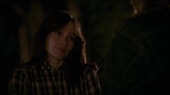 Movie still from “The House of the Devil” (2009), directed by Ti West – A woman in a plaid shirt is looking at the camera; Close Up shot, Over the shoulder angle