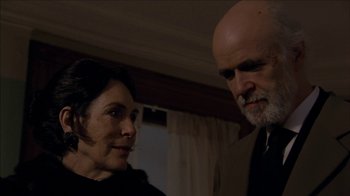 Movie still from “The House of the Devil” (2009), directed by Ti West – A man and a woman standing next to each other in a room; Close Up shot, Low angle