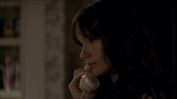 Movie still from “The House of the Devil” (2009), directed by Ti West – A woman holding a phone up to her ear; Close Up shot, High angle