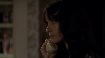Movie still from “The House of the Devil” (2009), directed by Ti West – A woman holding a phone up to her ear; Close Up shot, Over the shoulder angle