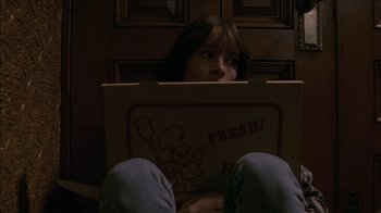 Movie still from “The House of the Devil” (2009), directed by Ti West – A person laying on the floor with their feet on the ground; Medium shot, Low angle