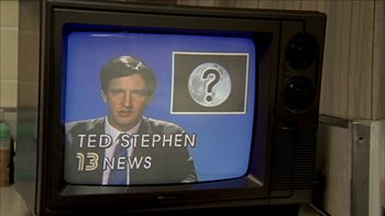 Movie still from “The House of the Devil” (2009), directed by Ti West – A television screen with a man on it and a question mark on it; Close Up shot, High angle