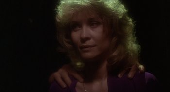 Movie still from “The Howling” (1981), directed by Joe Dante – A person wearing a purple shirt; Close Up shot, Over the shoulder angle