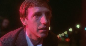 Movie still from “The Howling” (1981), directed by Joe Dante – A person wearing a suit and tie; Close Up shot, Over the shoulder angle