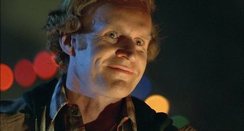 Movie still from “The Howling” (1981), directed by Joe Dante – A person wearing a plaid shirt; Close Up shot, Low angle