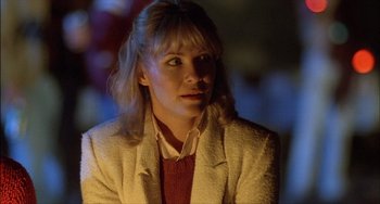 Movie still from “The Howling” (1981), directed by Joe Dante – A woman with blonde hair wearing a white jacket; Close Up shot, Over the shoulder angle