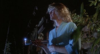 Movie still from “The Howling” (1981), directed by Joe Dante – A woman holding a blow dryer in her hand; Close Up shot, Low angle