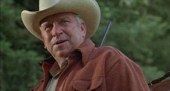 Movie still from “The Howling” (1981), directed by Joe Dante – An older man wearing a cowboy hat and a brown jacket; Close Up shot, Low angle