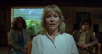 Movie still from “The Howling” (1981), directed by Joe Dante – A woman in a white shirt is sitting in front of a window; Close Up shot, Over the shoulder angle