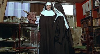 Movie still from “The Howling” (1981), directed by Joe Dante – A couple of people dressed up like nuns; Medium shot, Over the shoulder angle