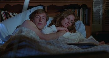 Movie still from “The Howling” (1981), directed by Joe Dante – A man and a woman sleeping in a bed; Medium shot, High angle