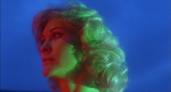Movie still from “The Howling” (1981), directed by Joe Dante – A beautiful woman with blonde curly hair in the dark; Close Up shot, Low angle