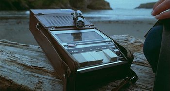 Movie still from “The Howling” (1981), directed by Joe Dante – An old radio sitting on top of a wooden table; Close Up shot, High angle