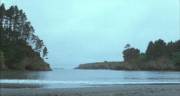 Movie still from “The Howling” (1981), directed by Joe Dante – A view of the ocean from the beach at dusk; Extreme Wide shot, Low angle