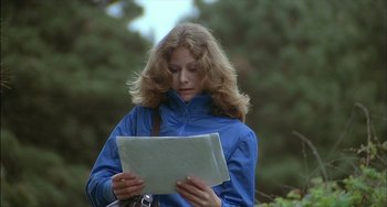 Movie still from “The Howling” (1981), directed by Joe Dante – A woman in a blue jacket holding a piece of paper; Close Up shot, Over the shoulder angle