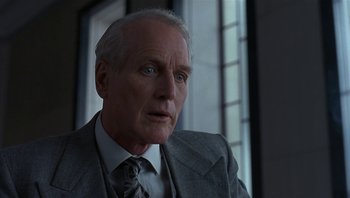 Movie still from “The Hudsucker Proxy” (1994), directed by Ethan Coen – An older man wearing a suit and tie; Close Up shot, Low angle