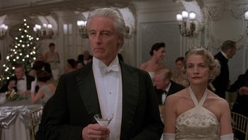 Movie still from “The Hudsucker Proxy” (1994), directed by Ethan Coen – A man in a tuxedo holding a glass of wine; Medium shot, Low angle